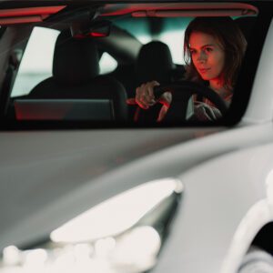 woman driving car at night